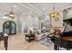 Expansive living area with fireplace, piano, and elegant arched doorways at 14724 Avenue Of The Rushes, Winter Garden, FL 34787