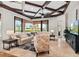 Bright living room with coffered ceilings, travertine floors, and views to outdoor living at 14724 Avenue Of The Rushes, Winter Garden, FL 34787