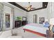 Well-lit primary bedroom featuring tray ceilings, access to the patio, and a seating area at 14724 Avenue Of The Rushes, Winter Garden, FL 34787