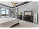 Spacious main bedroom features a view of the pool, tray ceilings, and dark wood dressers at 14724 Avenue Of The Rushes, Winter Garden, FL 34787