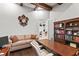 Comfortable home office space with custom wood built-ins and a cozy sofa seating area at 14724 Avenue Of The Rushes, Winter Garden, FL 34787