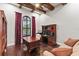 Home office features built in bookshelves, dark wood floors, and an arched window at 14724 Avenue Of The Rushes, Winter Garden, FL 34787