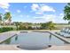 Inviting rectangular pool with comfortable chaise lounges, overlooking a picturesque lake at 14724 Avenue Of The Rushes, Winter Garden, FL 34787