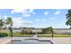 Sparkling pool with views of the lake, surrounded by lush greenery and comfortable lounge seating at 14724 Avenue Of The Rushes, Winter Garden, FL 34787