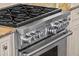 Close up of stainless steel range with six burners, oven, and custom cabinets at 14724 Avenue Of The Rushes, Winter Garden, FL 34787