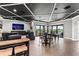 Spacious recreation room featuring a dark coffered ceiling, bar, and outdoor access at 14724 Avenue Of The Rushes, Winter Garden, FL 34787