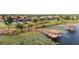 Beautiful waterfront property featuring a private dock and boat lift, surrounded by lush greenery and serene water lilies at 14724 Avenue Of The Rushes, Winter Garden, FL 34787