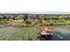 Waterfront property boasts a private dock with a boat lift, offering serene lake views and access for boating enthusiasts at 14724 Avenue Of The Rushes, Winter Garden, FL 34787