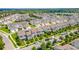 Wide aerial view of a neighborhood featuring many houses, mature trees, and cars on the streets at 15030 Book Club Rd, Winter Garden, FL 34787