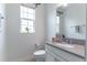 Well-lit powder room featuring a modern vanity with gray countertop and stylish mirror at 15030 Book Club Rd, Winter Garden, FL 34787