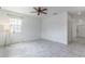 Bright and airy bedroom with tile floors, ceiling fan, and large windows offering natural light at 15030 Book Club Rd, Winter Garden, FL 34787