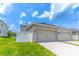 A spacious three car garage and well-manicured lawn enhance this home's curb appeal and functionality at 15030 Book Club Rd, Winter Garden, FL 34787