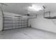 Garage with roll up door, painted walls, and overhead storage racks at 15030 Book Club Rd, Winter Garden, FL 34787