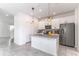 Bright kitchen features white cabinets, a kitchen island and stainless steel appliances at 15030 Book Club Rd, Winter Garden, FL 34787