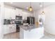 Kitchen with stainless steel appliances, island, and stylish pendant lighting at 15030 Book Club Rd, Winter Garden, FL 34787