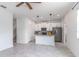 Bright open concept kitchen boasts white cabinets, stainless steel appliances and tiled floors at 15030 Book Club Rd, Winter Garden, FL 34787