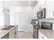White kitchen boasts stainless steel appliances and a gray backsplash at 15030 Book Club Rd, Winter Garden, FL 34787