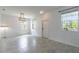 Bright living room showcasing neutral walls, modern light fixture, and tile floors for a clean aesthetic at 15030 Book Club Rd, Winter Garden, FL 34787