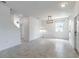 Bright living room showcasing neutral walls, modern light fixture, and tile floors for a clean aesthetic at 15030 Book Club Rd, Winter Garden, FL 34787