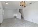 Bright living room showcasing neutral walls, modern light fixture, and tile floors for a clean aesthetic at 15030 Book Club Rd, Winter Garden, FL 34787