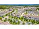 Wide aerial view of a neighborhood featuring many houses, mature trees, and cars on the streets at 15030 Book Club Rd, Winter Garden, FL 34787