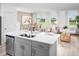 Open-concept kitchen featuring stainless steel appliances, breakfast bar, and seamless access to the living area at 16382 Bird Of Paradise Ave, Clermont, FL 34714
