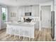 Bright, eat-in kitchen with white countertops, modern appliances, and light wood flooring at 16382 Bird Of Paradise Ave, Clermont, FL 34714