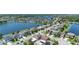 Neighborhood aerial showcasing homes by the lake with lush green landscaping and community access to waterways at 1902 Hailsham Ct, Orlando, FL 32824