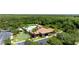 Aerial view of the community pool, clubhouse, playground, and green spaces surrounded by tropical trees and lush greenery at 1902 Hailsham Ct, Orlando, FL 32824