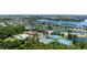 Aerial of community amenities including a sparkling pool, tennis courts, a community clubhouse, and scenic views of the lake at 1902 Hailsham Ct, Orlando, FL 32824