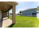 Lush backyard with manicured lawn, covered patio, and privacy fence at 1902 Hailsham Ct, Orlando, FL 32824