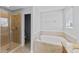 Bathroom featuring soaking tub, glass shower, and natural light at 1902 Hailsham Ct, Orlando, FL 32824
