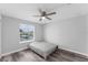 Clean bedroom featuring wood-look floors, ceiling fan, window and neutral decor at 1902 Hailsham Ct, Orlando, FL 32824
