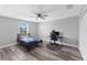 This bedroom has wood-look flooring and an overhead fan with light at 1902 Hailsham Ct, Orlando, FL 32824