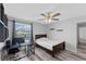 Comfortable bedroom features wood-look floors, ceiling fan, and desk area near window at 1902 Hailsham Ct, Orlando, FL 32824