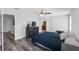 Bedroom with hardwood floors, ceiling fan, and a bathroom visible in the background at 1902 Hailsham Ct, Orlando, FL 32824