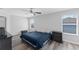 This bedroom has gray-tone wood-look flooring and two windows at 1902 Hailsham Ct, Orlando, FL 32824