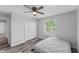Bright bedroom featuring wood-look floors, window with blinds and a closet at 1902 Hailsham Ct, Orlando, FL 32824