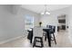 Bright dining area featuring a modern chandelier and a window with natural light at 1902 Hailsham Ct, Orlando, FL 32824