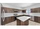 Modern kitchen boasts sleek wood cabinets, quartz countertops, and stainless steel appliances at 1902 Hailsham Ct, Orlando, FL 32824