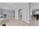 Open living area featuring neutral tones, tile floors, and seamless access to additional rooms at 1902 Hailsham Ct, Orlando, FL 32824