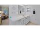 Bathroom featuring a mirrored wall, vanity, and lighting at 200 Palm Meadows Dr, Eustis, FL 32726