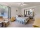 This bedroom features a bed, chair, nightstand and mirrored closet at 200 Palm Meadows Dr, Eustis, FL 32726