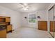 The empty bedroom features carpet, a ceiling fan, and a dresser with mirror at 200 Palm Meadows Dr, Eustis, FL 32726