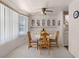 Bright dining area with a round table, wooden chairs, and a built-in cabinet with glass doors for display at 200 Palm Meadows Dr, Eustis, FL 32726