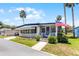 Cozy home with an American flag, featuring a well-kept lawn and inviting entrance at 200 Palm Meadows Dr, Eustis, FL 32726
