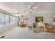 Living room and dining area showing neutral carpet, ceiling fans, and natural light throughout at 200 Palm Meadows Dr, Eustis, FL 32726