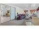 Bright sun room featuring cozy furniture, carpet, and large sliding glass door leading to living room at 200 Palm Meadows Dr, Eustis, FL 32726