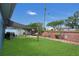 Landscaped backyard featuring a covered patio, a seating area and plenty of grass at 204 Bay Meadow Dr, Kissimmee, FL 34746