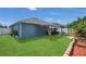 Landscaped backyard featuring a covered patio, a seating area and plenty of grass at 204 Bay Meadow Dr, Kissimmee, FL 34746